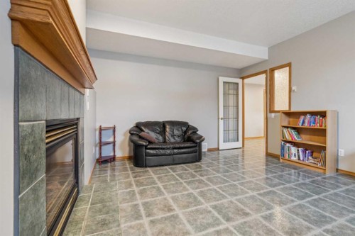 10 Bow Ridge Lane, Cochrane, AB - Indoor With Fireplace