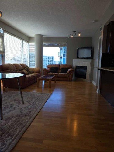 2208-910 5 Avenue Sw, Calgary, AB - Indoor Photo Showing Living Room With Fireplace