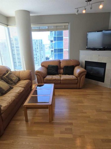 2208-910 5 Avenue Sw, Calgary, AB - Indoor Photo Showing Living Room With Fireplace