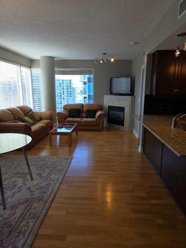 2208-910 5 Avenue Sw, Calgary, AB - Indoor Photo Showing Living Room With Fireplace