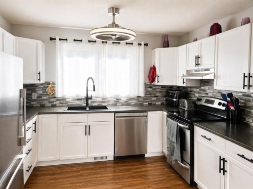 2452 Riverstone Road Se, Calgary, AB - Indoor Photo Showing Kitchen With Stainless Steel Kitchen With Double Sink