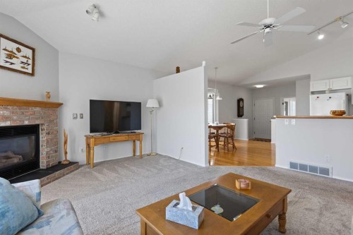 303 De Foras Close Nw, High River, AB - Indoor Photo Showing Living Room With Fireplace