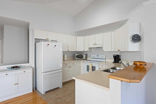 303 De Foras Close Nw, High River, AB - Indoor Photo Showing Kitchen With Double Sink
