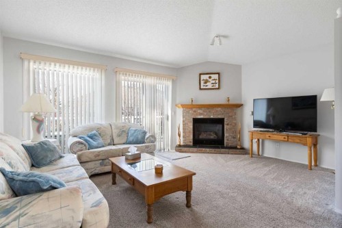 303 De Foras Close Nw, High River, AB - Indoor Photo Showing Living Room With Fireplace