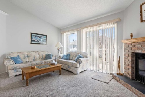 303 De Foras Close Nw, High River, AB - Indoor Photo Showing Living Room With Fireplace