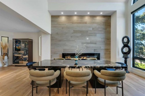 931 Shawnee Drive Sw, Calgary, AB - Indoor Photo Showing Dining Room With Fireplace