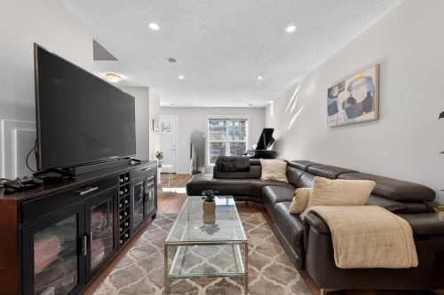 340 Cranbrook Square Se, Calgary, AB - Indoor Photo Showing Living Room With Fireplace