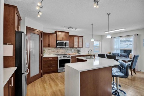 1009 Channelside Way Sw, Airdrie, AB - Indoor Photo Showing Kitchen With Upgraded Kitchen