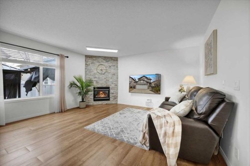1009 Channelside Way Sw, Airdrie, AB - Indoor Photo Showing Living Room With Fireplace