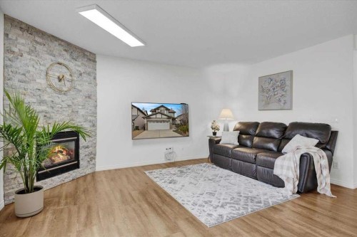 1009 Channelside Way Sw, Airdrie, AB - Indoor Photo Showing Living Room With Fireplace