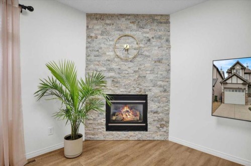 1009 Channelside Way Sw, Airdrie, AB - Indoor Photo Showing Living Room With Fireplace