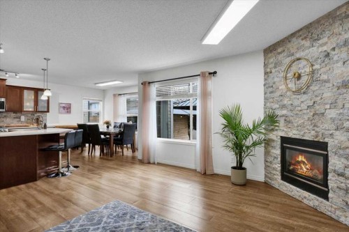 1009 Channelside Way Sw, Airdrie, AB - Indoor Photo Showing Living Room With Fireplace