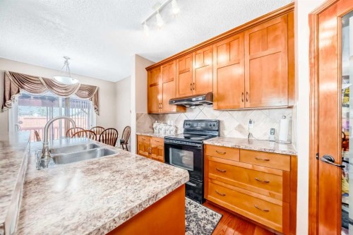 148 Saddlecrest Gardens Ne, Calgary, AB - Indoor Photo Showing Kitchen With Double Sink