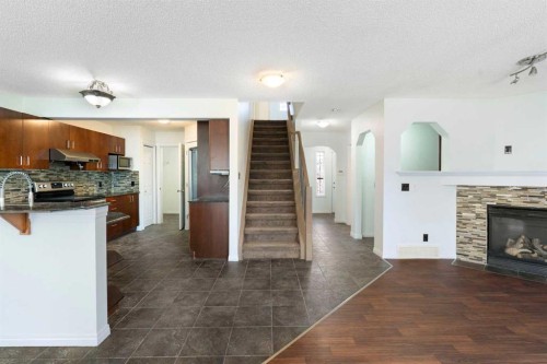 231 Hawkmere Road, Chestermere, AB - Indoor Photo Showing Kitchen With Fireplace