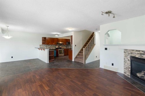 231 Hawkmere Road, Chestermere, AB - Indoor Photo Showing Other Room With Fireplace