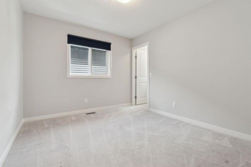 107 Sundown View, Cochrane, AB - Indoor Photo Showing Other Room
