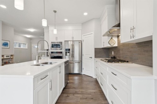107 Sundown View, Cochrane, AB - Indoor Photo Showing Kitchen With Double Sink With Upgraded Kitchen