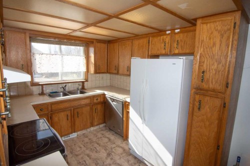 27 Taraglen Court Ne, Calgary, AB - Indoor Photo Showing Kitchen With Double Sink