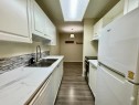 83E-231 Heritage Drive Se, Calgary, AB  - Indoor Photo Showing Kitchen With Double Sink 