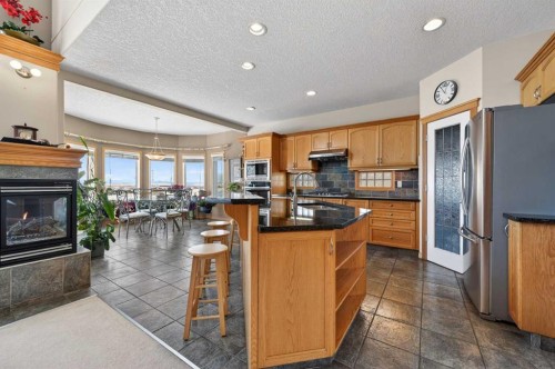 359 Rocky Ridge Drive Nw, Calgary, AB - Indoor Photo Showing Kitchen With Fireplace