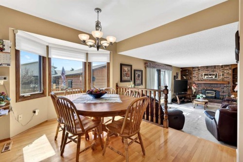 168 Templewood Drive Ne, Calgary, AB - Indoor Photo Showing Dining Room With Fireplace