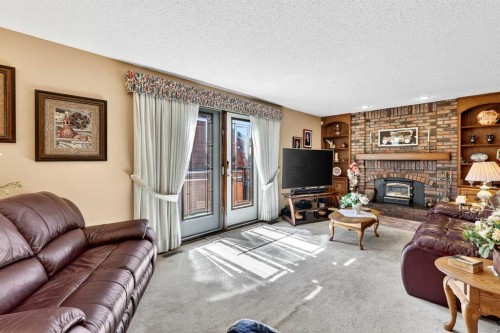 168 Templewood Drive Ne, Calgary, AB - Indoor Photo Showing Living Room With Fireplace