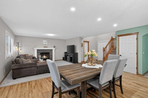 112 West Creek Close, Chestermere, AB - Indoor Photo Showing Dining Room With Fireplace