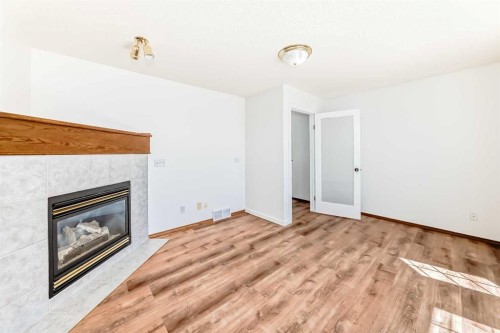141 Arbour Crest Mews Nw, Calgary, AB - Indoor Photo Showing Living Room With Fireplace