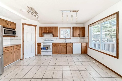 141 Arbour Crest Mews Nw, Calgary, AB - Indoor Photo Showing Kitchen With Double Sink