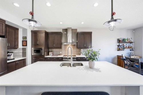 312 Sunset View, Cochrane, AB - Indoor Photo Showing Kitchen With Stainless Steel Kitchen With Double Sink With Upgraded Kitchen