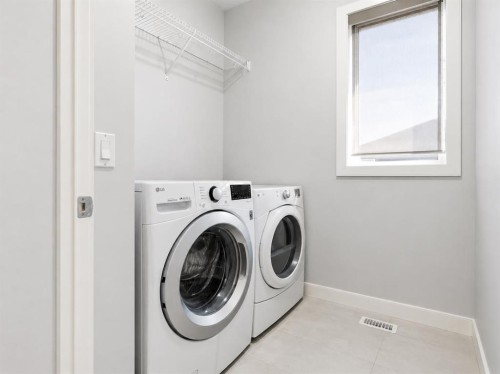 312 Sunset View, Cochrane, AB - Indoor Photo Showing Laundry Room