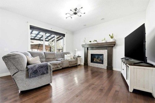 312 Sunset View, Cochrane, AB - Indoor Photo Showing Living Room With Fireplace