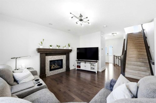 312 Sunset View, Cochrane, AB - Indoor Photo Showing Living Room With Fireplace