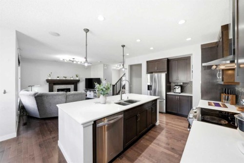 312 Sunset View, Cochrane, AB - Indoor Photo Showing Kitchen With Stainless Steel Kitchen With Double Sink With Upgraded Kitchen
