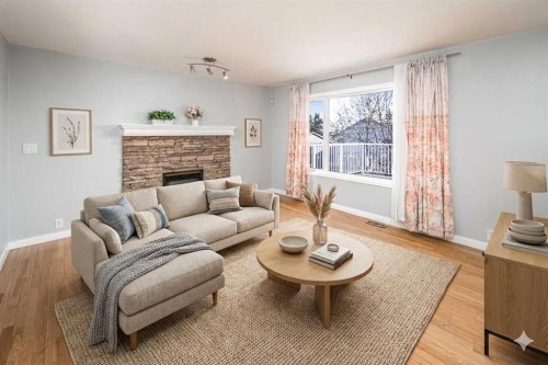 10 Somerset Court Sw, Calgary, AB - Indoor Photo Showing Living Room With Fireplace