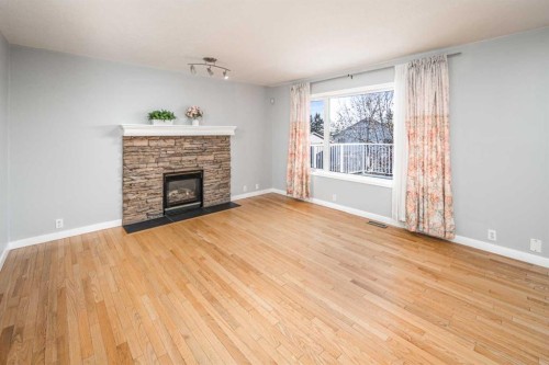 10 Somerset Court Sw, Calgary, AB - Indoor Photo Showing Living Room With Fireplace