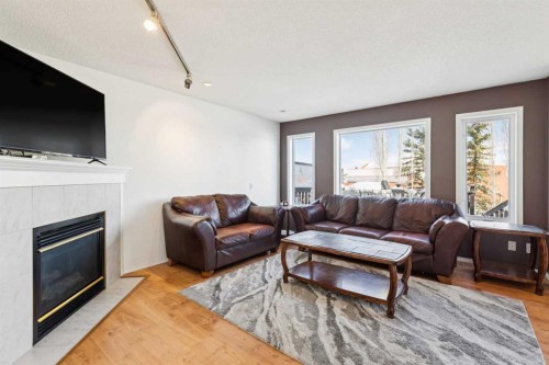 18 Bridlewood Way Sw, Calgary, AB - Indoor Photo Showing Living Room With Fireplace