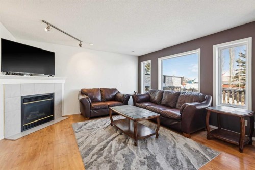 18 Bridlewood Way Sw, Calgary, AB - Indoor Photo Showing Living Room With Fireplace