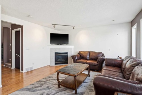 18 Bridlewood Way Sw, Calgary, AB - Indoor Photo Showing Living Room With Fireplace