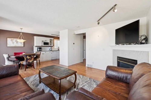 18 Bridlewood Way Sw, Calgary, AB - Indoor Photo Showing Living Room With Fireplace