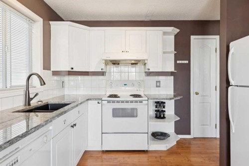 18 Bridlewood Way Sw, Calgary, AB - Indoor Photo Showing Kitchen With Double Sink