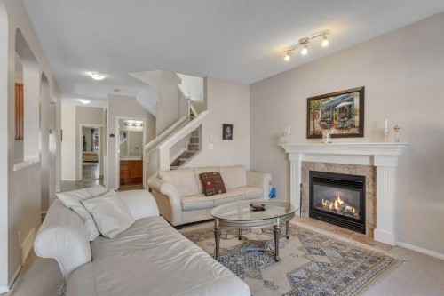 149 Saddlecrest Green Ne, Calgary, AB - Indoor Photo Showing Living Room With Fireplace