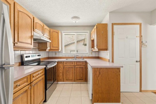 404 Manora Way Ne, Calgary, AB - Indoor Photo Showing Kitchen With Double Sink
