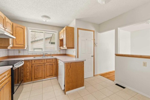 404 Manora Way Ne, Calgary, AB - Indoor Photo Showing Kitchen With Double Sink