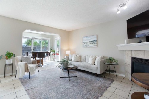 403 Morningside Way Sw, Airdrie, AB - Indoor Photo Showing Living Room With Fireplace