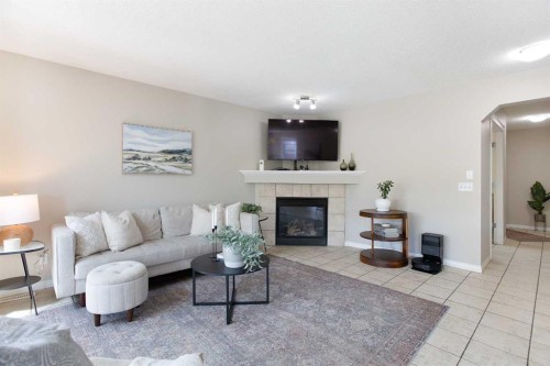403 Morningside Way Sw, Airdrie, AB - Indoor Photo Showing Living Room With Fireplace