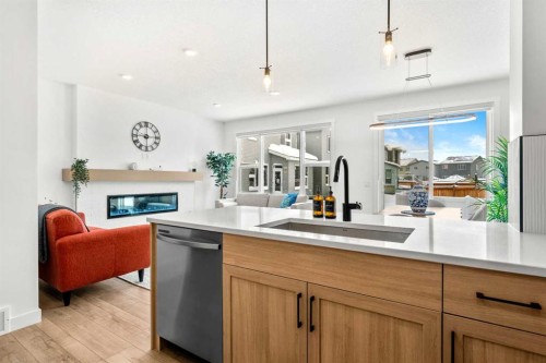 20 Walgrove Heights Se, Calgary, AB - Indoor Photo Showing Kitchen With Fireplace