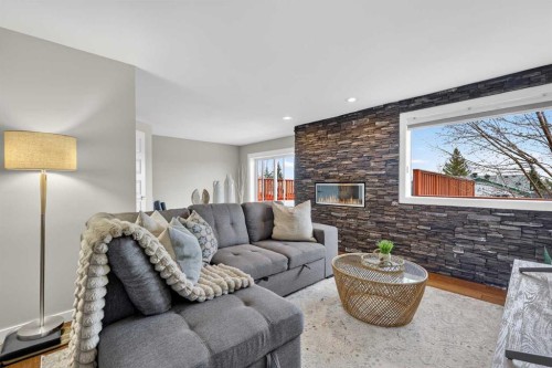 263 Shawmeadows Road Sw, Calgary, AB - Indoor Photo Showing Living Room With Fireplace