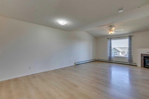 301-7301 Valleyview Park Se, Calgary, AB - Indoor Photo Showing Other Room With Fireplace
