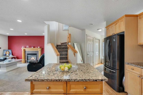 133 Everwoods Close Sw, Calgary, AB - Indoor Photo Showing Kitchen With Fireplace